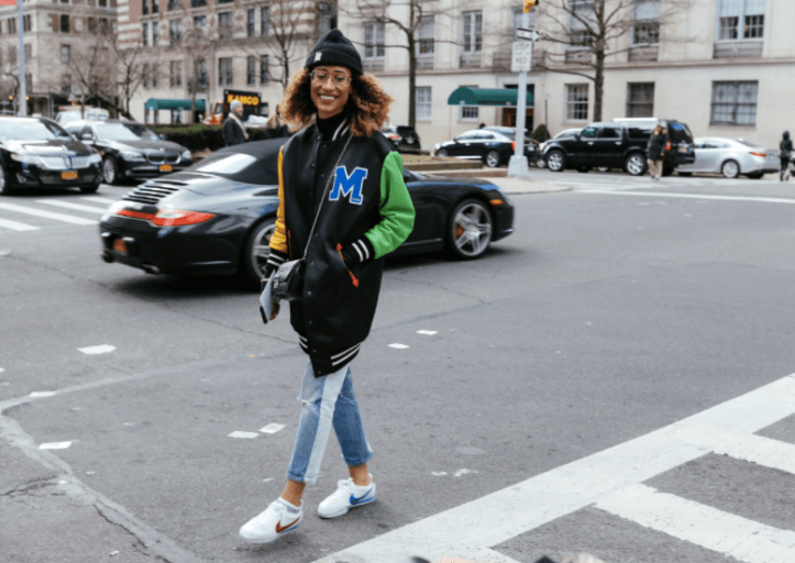 Elaine Welteroth in a Moschino jacket and Nike shoes NYFW Fall 2017 by Phil Oh